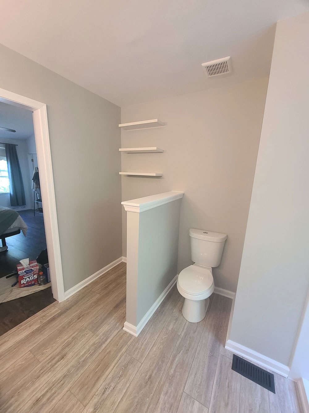 New LVT flooring, toilet, and floating shelves