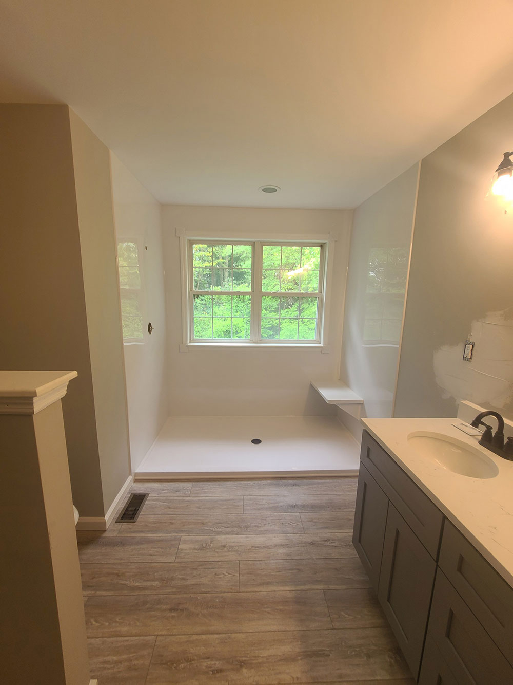 The bulking soaking tub was turned into a custom 84 x 44 shower base with our Onyx shower base.